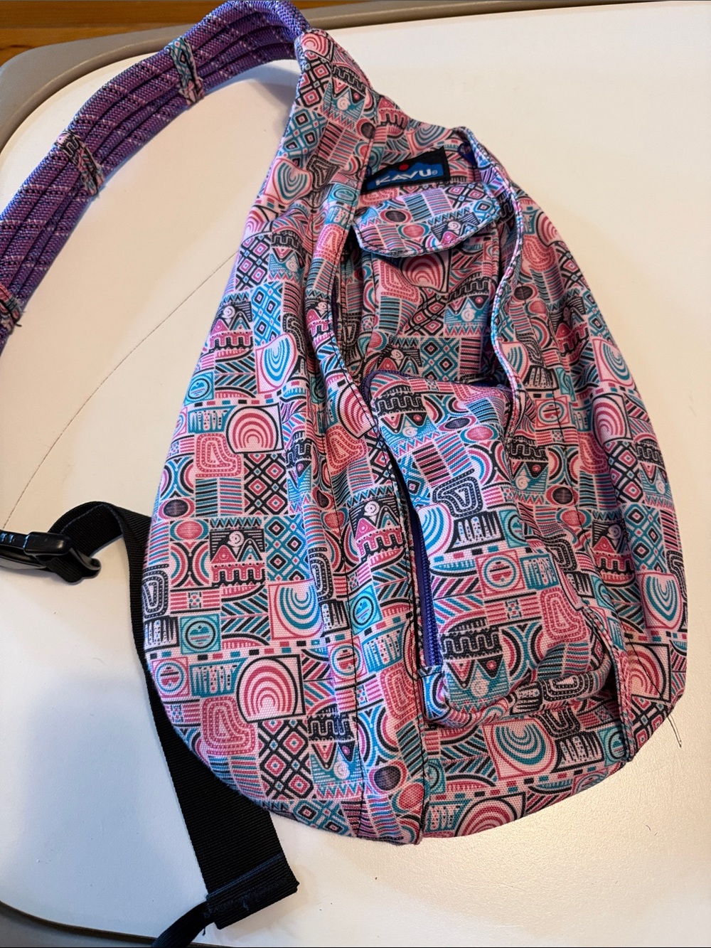 KAVU brand rope sling bag in Pastel Chalk pattern. Pink, teal, purple.